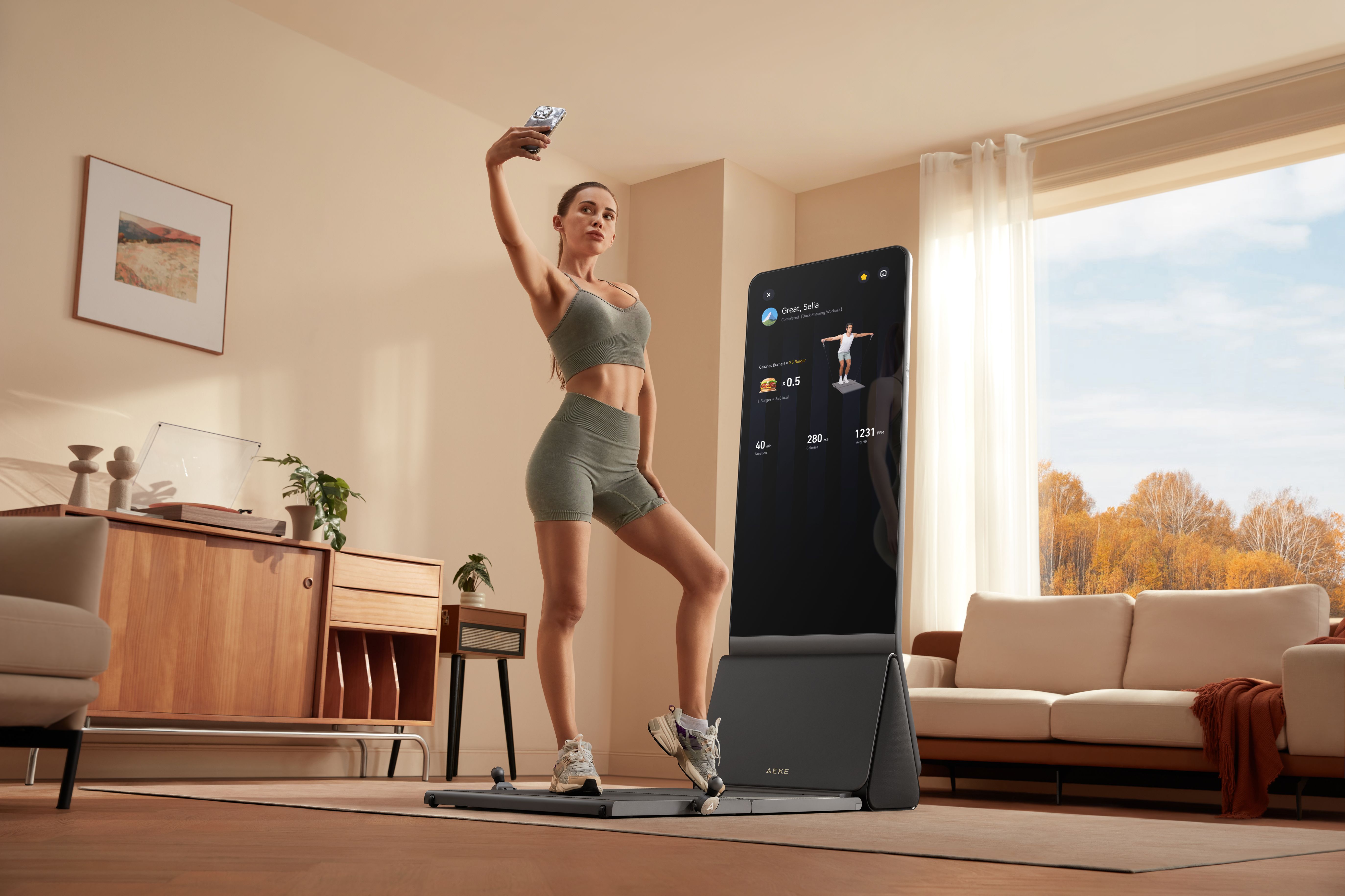 A woman in activewear takes a selfie while using a smart home gym with an interactive fitness mirror.