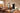 Man exercising on an AEKE smart home gym mirror in a sunny living room.