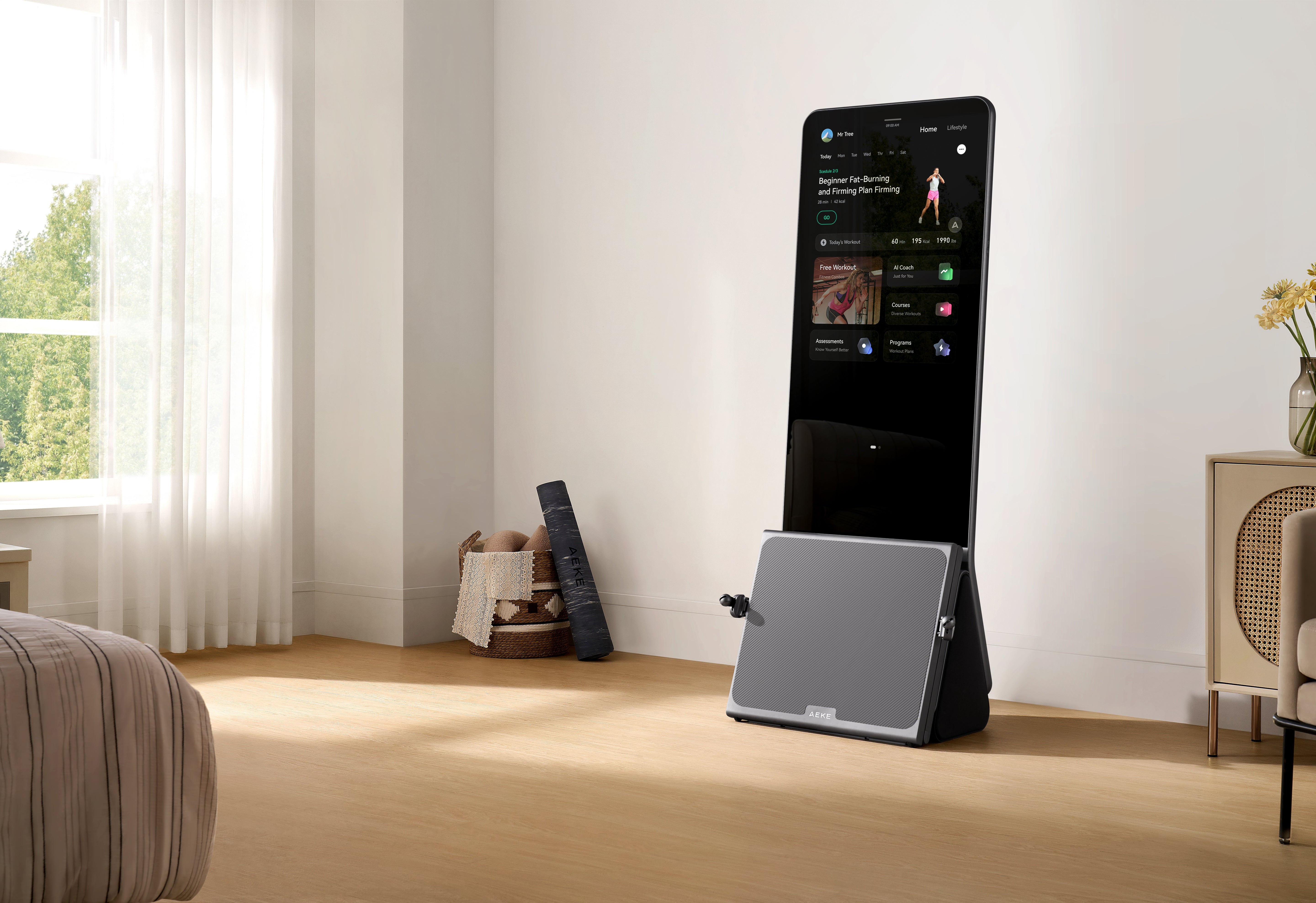 Tablet displaying a fitness app beside a tilted gray panel in a bright living room