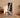 A woman performing a yoga lunge while following an instructor on a smart fitness mirror.