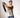 A man performing a standing torso rotation using a smart cable home gym.