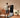 A man is exercising at home in front of a touchscreen fitness mirror.