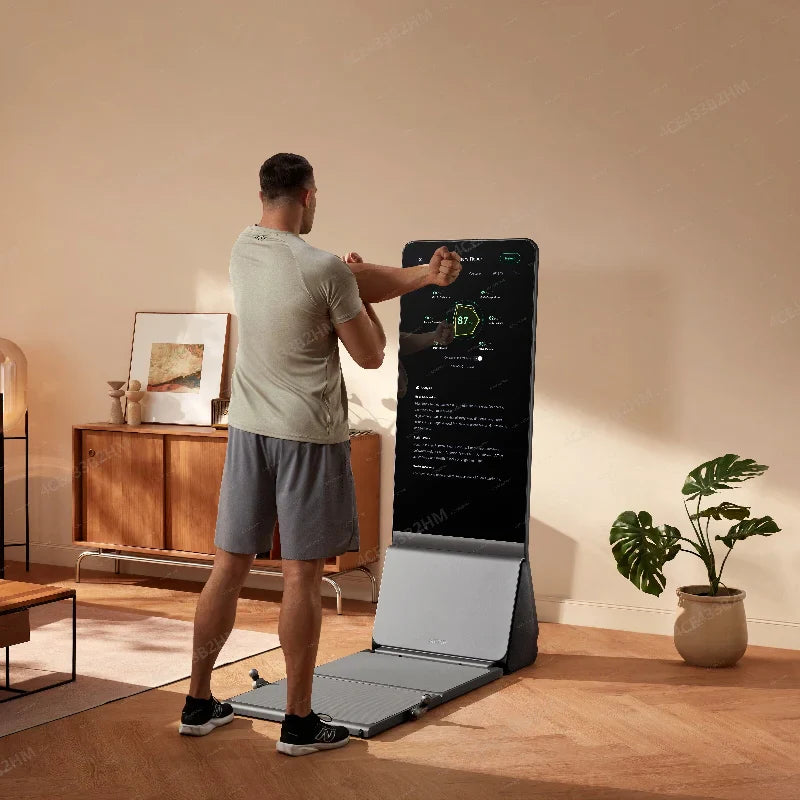 A man is exercising at home in front of a touchscreen fitness mirror.