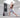 Woman holding a lunge beside a fitness screen in a home workout space