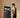 A man in fitness gear interacting with a large smart mirror display to select a workout.