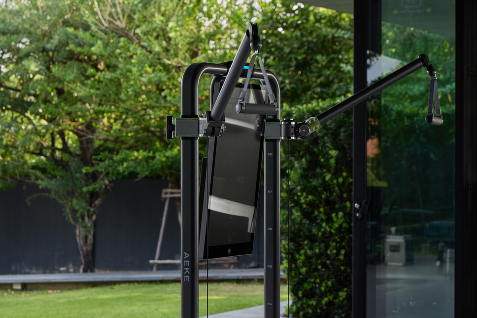 Black freestanding equipment stand with a tilted display and an articulated arm outdoors