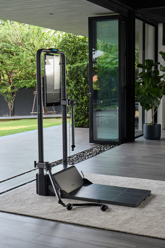 Compact home strength-training machine standing on a light rug in a modern room
