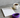 A training schedule notebook beside a steaming coffee and a resistance band.