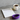 A training schedule notebook beside a steaming coffee and a resistance band.