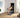 A woman exercises on a bench with a mirrored smart home gym in a modern room.