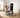 A man sits on a bench, using a smart fitness mirror and resistance bands for a full home workout.