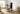 A man sits on a bench, using a smart fitness mirror and resistance bands for a full home workout.