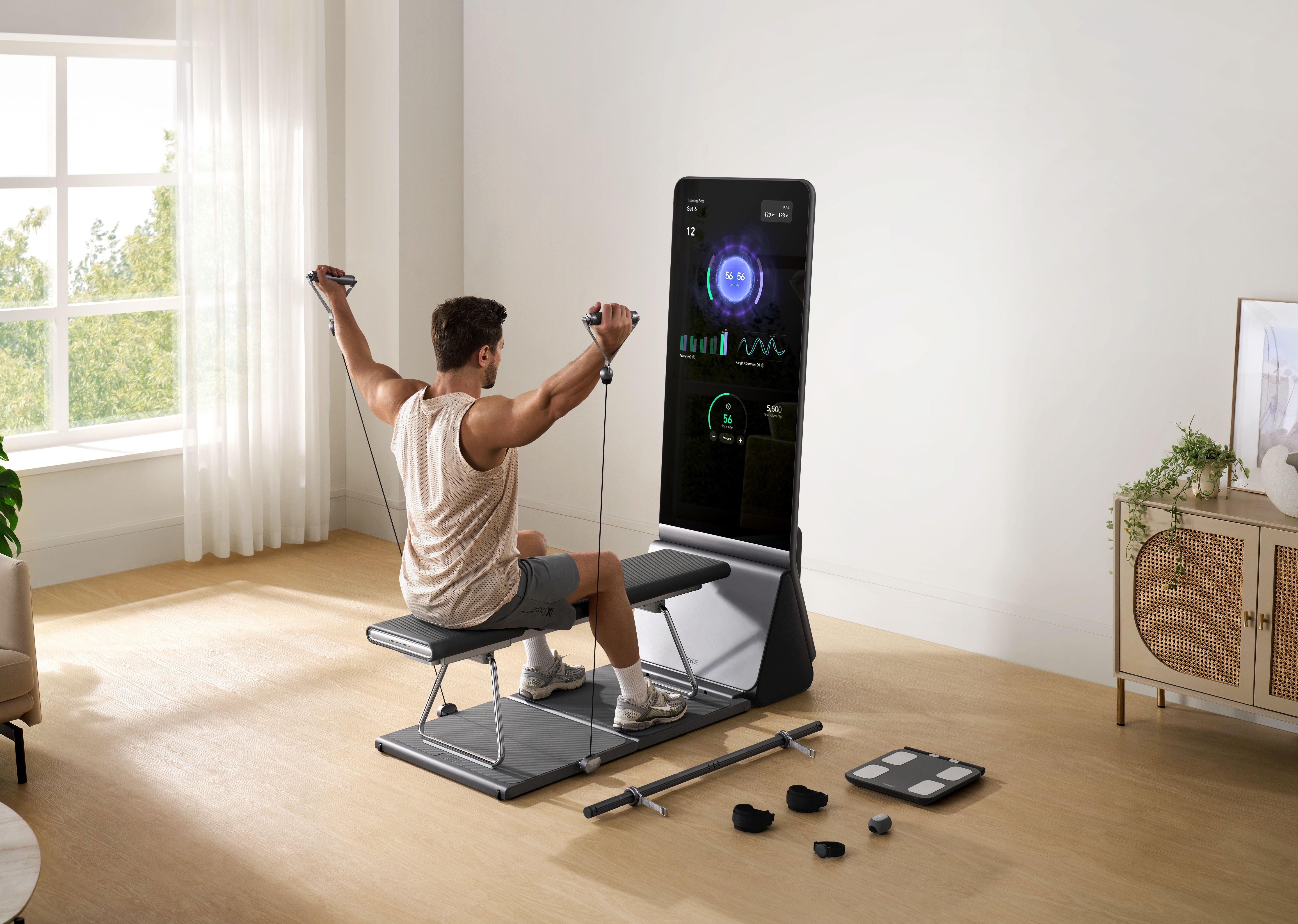 Man using a connected cable resistance machine for an upper-body workout at home